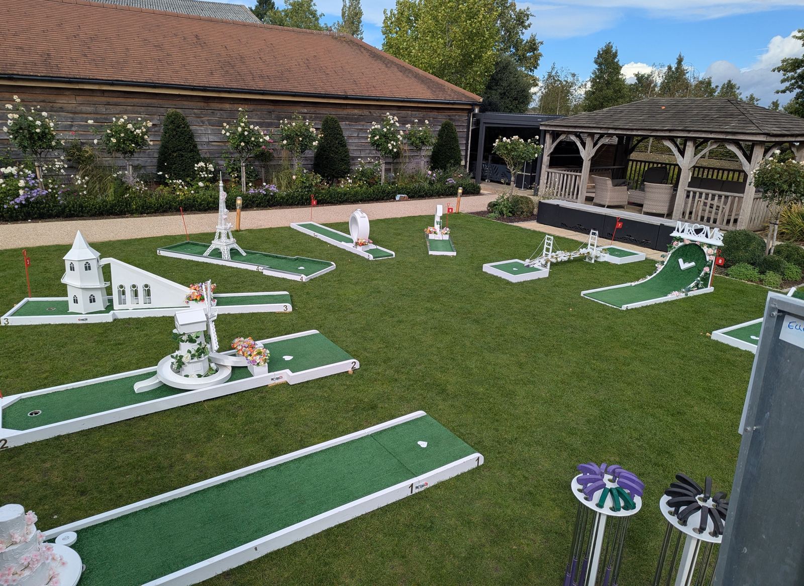 Wedding guests playing crazy golf at Bassmead Manor Barns
